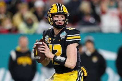 Dec 23, 2022; Tampa, Florida, USA; Missouri Tigers quarterback Brady Cook (12) drops back to pass against the Wake Forest Demon Deacons in the first quarter in the 2022 Gasparilla Bowl at Raymond James Stadium. Mandatory Credit: Nathan Ray Seebeck-USA TODAY Sports