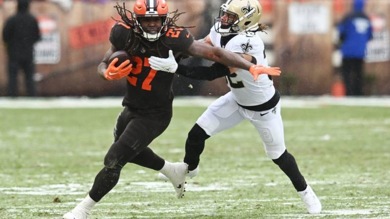 Dec 24, 2022; Cleveland, Ohio, USA; New Orleans Saints safety Tyrann Mathieu (32) tackles Cleveland Browns running back Kareem Hunt (27) during the first half at FirstEnergy Stadium. Mandatory Credit: Ken Blaze-USA TODAY Sports