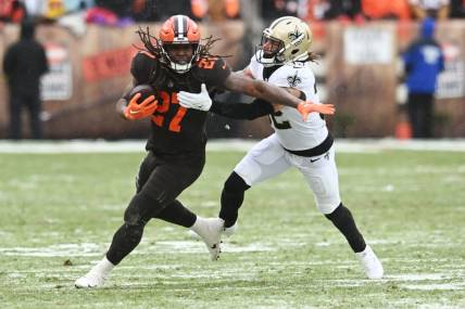 Dec 24, 2022; Cleveland, Ohio, USA; New Orleans Saints safety Tyrann Mathieu (32) tackles Cleveland Browns running back Kareem Hunt (27) during the first half at FirstEnergy Stadium. Mandatory Credit: Ken Blaze-USA TODAY Sports