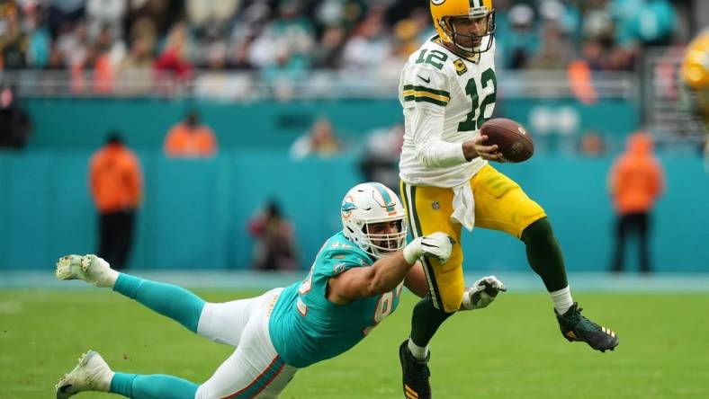 Dec 25, 2022; Miami Gardens, Florida, USA; Miami Dolphins defensive tackle Zach Sieler (92) reaches for Green Bay Packers quarterback Aaron Rodgers (12) during the second half at Hard Rock Stadium. Mandatory Credit: Jasen Vinlove-USA TODAY Sports