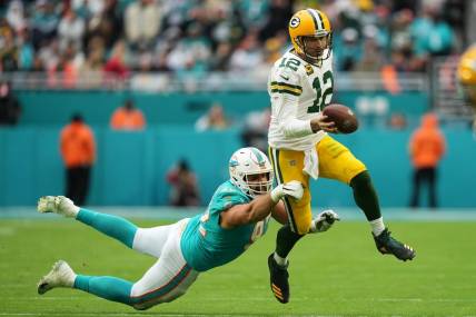Dec 25, 2022; Miami Gardens, Florida, USA; Miami Dolphins defensive tackle Zach Sieler (92) reaches for Green Bay Packers quarterback Aaron Rodgers (12) during the second half at Hard Rock Stadium. Mandatory Credit: Jasen Vinlove-USA TODAY Sports