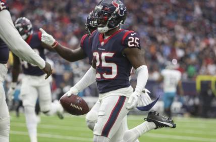 Jan 1, 2023; Houston, Texas, USA; Houston Texans cornerback Desmond King II (25) runs with the ball after a Texans interception during the second quarter against the Jacksonville Jaguars at NRG Stadium. Mandatory Credit: Troy Taormina-USA TODAY Sports