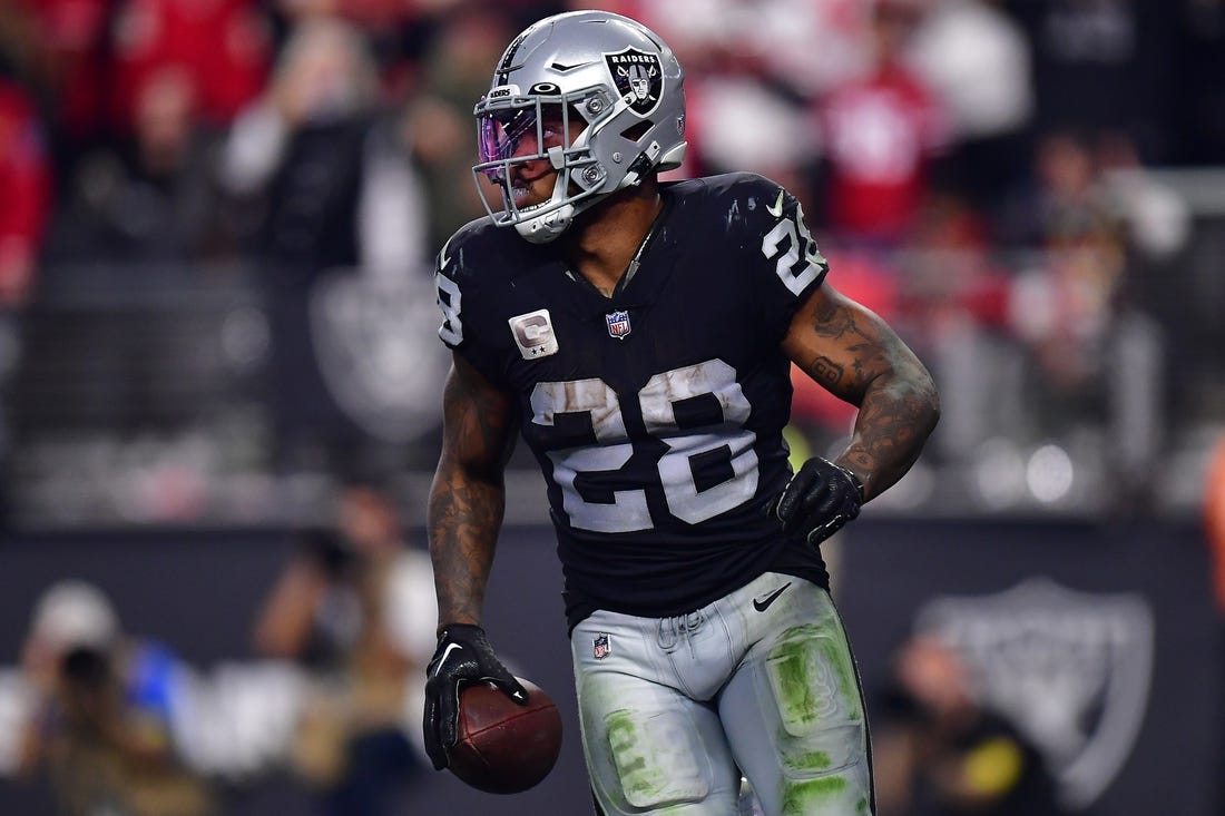 January 1, 2023; Paradise, Nevada, USA; Las Vegas Raiders running back Josh Jacobs (28) scores a touchdown against the San Francisco 49ers during the second half at Allegiant Stadium. Mandatory Credit: Gary A. Vasquez-USA TODAY Sports