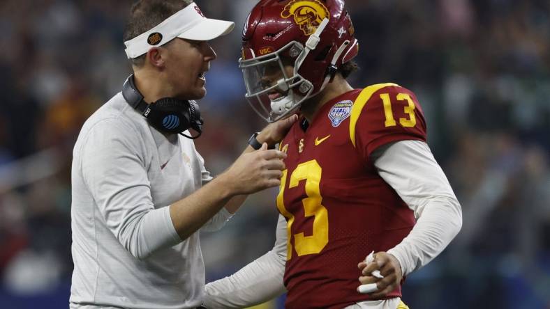 Jan 2, 2023; Arlington, Texas, USA; USC Trojans head coach Lincoln Riley talks to quarterback Caleb Williams (13) during the game against the Tulane Green Wave in the 2023 Cotton Bowl at AT&T Stadium. Mandatory Credit: Tim Heitman-USA TODAY Sports