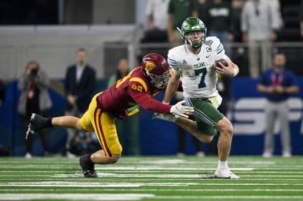 Jan 2, 2023; Arlington, Texas, USA; Tulane Green Wave quarterback Michael Pratt (7) and USC Trojans defensive lineman Nick Figueroa (99) in action during the game between the USC Trojans and the Tulane Green Wave in the 2023 Cotton Bowl at AT&T Stadium. Mandatory Credit: Jerome Miron-USA TODAY Sports
