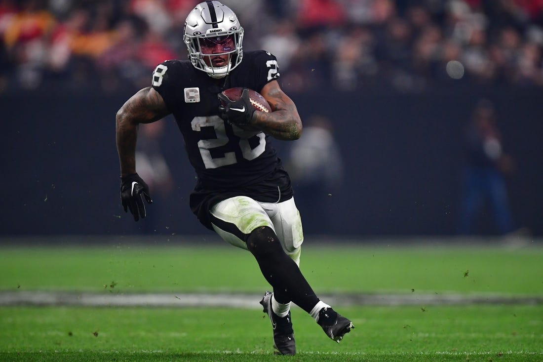 Jan 7, 2023; Paradise, Nevada, USA; Las Vegas Raiders running back Josh Jacobs (28) runs the ball against the Kansas City Chiefs during the second half at Allegiant Stadium. Mandatory Credit: Gary A. Vasquez-USA TODAY Sports