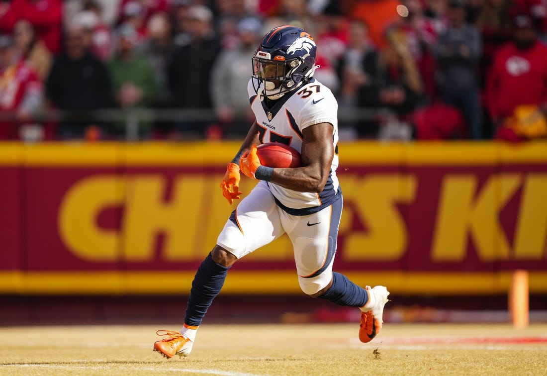 Jan 1, 2023; Kansas City, Missouri, USA; Denver Broncos running back Marlon Mack (37) returns a kickoff during the first half against the Kansas City Chiefs at GEHA Field at Arrowhead Stadium. Mandatory Credit: Jay Biggerstaff-USA TODAY Sports