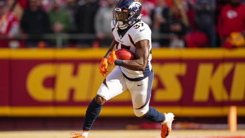 Jan 1, 2023; Kansas City, Missouri, USA; Denver Broncos running back Marlon Mack (37) returns a kickoff during the first half against the Kansas City Chiefs at GEHA Field at Arrowhead Stadium. Mandatory Credit: Jay Biggerstaff-USA TODAY Sports