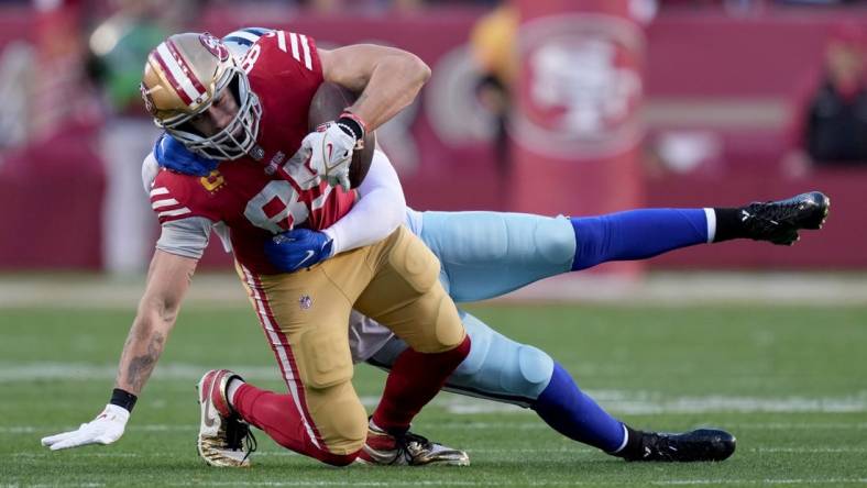 Jan 22, 2023; Santa Clara, California, USA; San Francisco 49ers tight end George Kittle (85) is tackled by Dallas Cowboys linebacker Anthony Barr (42) during the second quarter of a NFC divisional round game at Levi's Stadium. Mandatory Credit: Kyle Terada-USA TODAY Sports