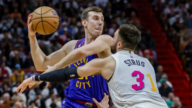 Feb 13, 2023; Miami, Florida, USA; Denver Nuggets forward Vlatko Cancar (31) protects the basketball from Miami Heat guard Max Strus (31) during the third quarter at Miami-Dade Arena. Mandatory Credit: Sam Navarro-USA TODAY Sports