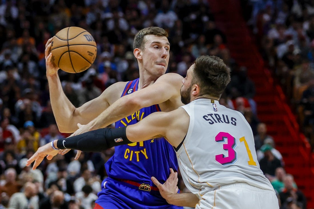 Feb 13, 2023; Miami, Florida, USA; Denver Nuggets forward Vlatko Cancar (31) protects the basketball from Miami Heat guard Max Strus (31) during the third quarter at Miami-Dade Arena. Mandatory Credit: Sam Navarro-USA TODAY Sports