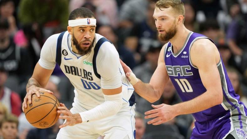 Feb 11, 2023; Sacramento, California, USA; Dallas Mavericks center JaVale McGee (00) handles the ball against Sacramento Kings forward Domantas Sabonis (10) during the third quarter at Golden 1 Center. Mandatory Credit: Darren Yamashita-USA TODAY Sports