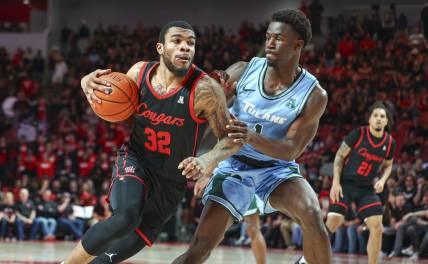 Feb 22, 2023; Houston, Texas, USA; Houston Cougars forward Reggie Chaney (32) drives with the ball as Tulane Green Wave guard Sion James (1) defends during the second half at Fertitta Center. Mandatory Credit: Troy Taormina-USA TODAY Sports