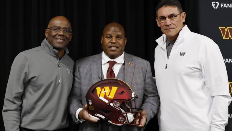 Feb 23, 2023; Ashburn, Virginia, USA; Eric Bieniemy (M) poses with Washington Commanders general manager Martin Mayhew (L) and Commanders head coach Ron Rivera (R) after being introduced as the new Commanders offensive coordinator and assistant head coach during an introductory press conference at Commanders Park. Mandatory Credit: Geoff Burke-USA TODAY Sports