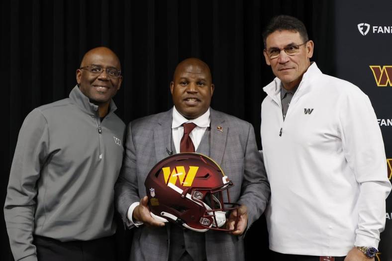 Feb 23, 2023; Ashburn, Virginia, USA; Eric Bieniemy (M) poses with Washington Commanders general manager Martin Mayhew (L) and Commanders head coach Ron Rivera (R) after being introduced as the new Commanders offensive coordinator and assistant head coach during an introductory press conference at Commanders Park. Mandatory Credit: Geoff Burke-USA TODAY Sports