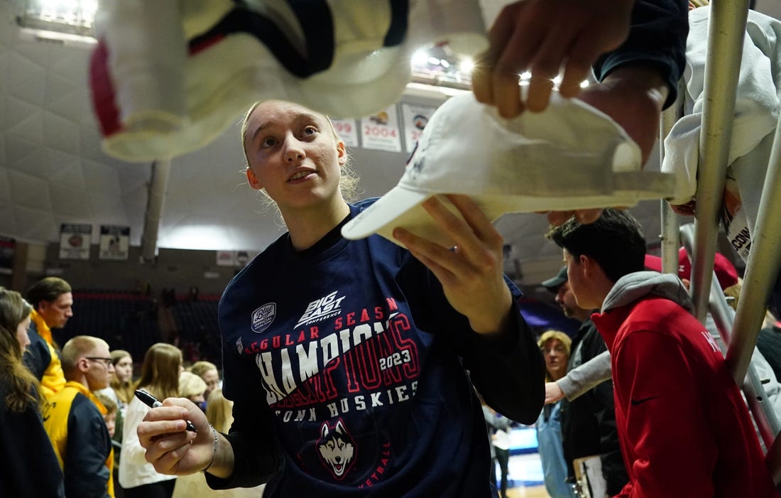 Feb 27, 2023; Storrs, Connecticut, USA; UConn Huskies guard Paige Bueckers (5) signs autographs after her teammates defeated the Xavier Musketeers at Harry A. Gampel Pavilion. Mandatory Credit: David Butler II-USA TODAY Sports