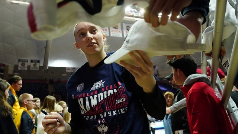 Feb 27, 2023; Storrs, Connecticut, USA; UConn Huskies guard Paige Bueckers (5) signs autographs after her teammates defeated the Xavier Musketeers at Harry A. Gampel Pavilion. Mandatory Credit: David Butler II-USA TODAY Sports