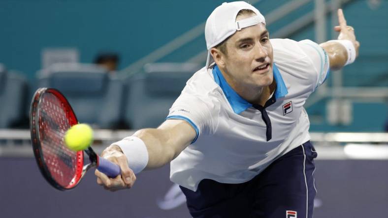 Mar 22, 2023; Miami, Florida, US; John Isner (USA) hits a volley against Emilio Nara (USA) (not pictured) on day three of the Miami Open at Hard Rock Stadium. Mandatory Credit: Geoff Burke-USA TODAY Sports