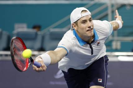 Mar 22, 2023; Miami, Florida, US; John Isner (USA) hits a volley against Emilio Nara (USA) (not pictured) on day three of the Miami Open at Hard Rock Stadium. Mandatory Credit: Geoff Burke-USA TODAY Sports