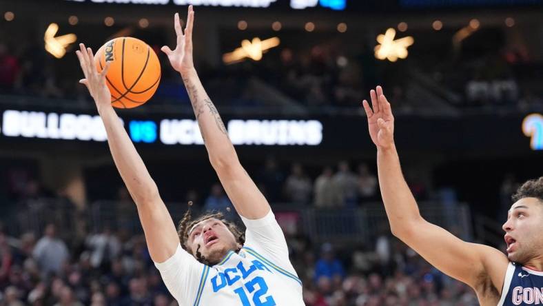 Mar 23, 2023; Las Vegas, NV, USA; UCLA Bruins forward Mac Etienne (12) reaches for the ball against Gonzaga Bulldogs forward Anton Watson (22) during the second half at T-Mobile Arena. Mandatory Credit: Joe Camporeale-USA TODAY Sports