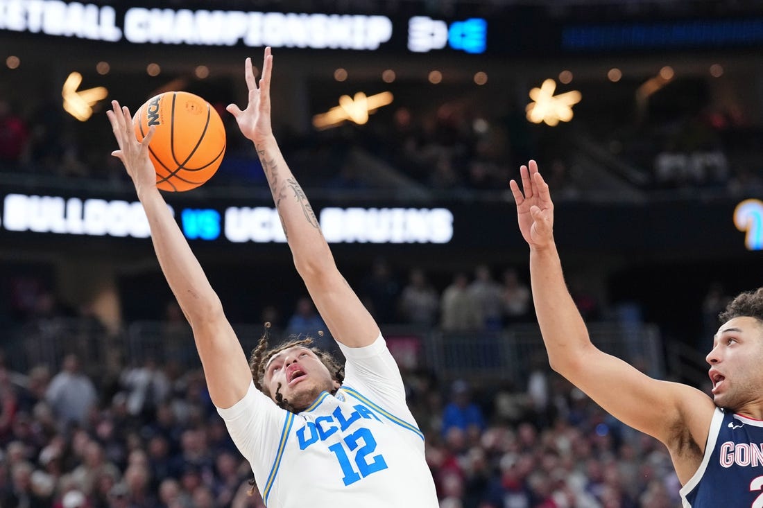 Mar 23, 2023; Las Vegas, NV, USA; UCLA Bruins forward Mac Etienne (12) reaches for the ball against Gonzaga Bulldogs forward Anton Watson (22) during the second half at T-Mobile Arena. Mandatory Credit: Joe Camporeale-USA TODAY Sports