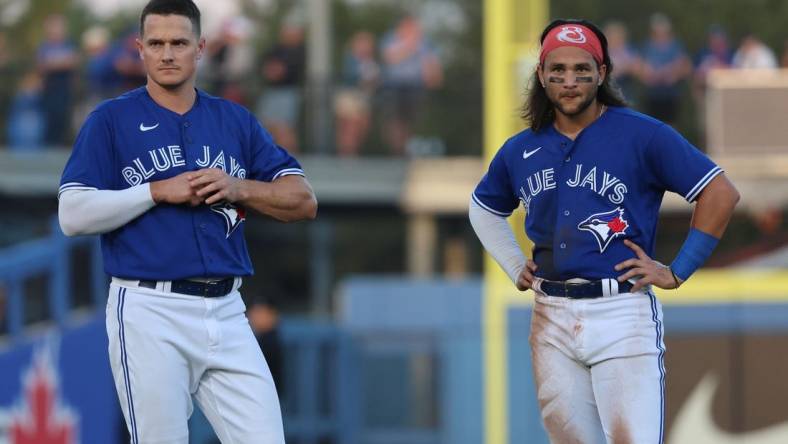 Mar 25, 2023; Dunedin, Florida, USA; Toronto Blue Jays third baseman Matt Chapman (26) and shortstop Bo Bichette (11) look on against the Detroit Tigers  at TD Ballpark. Mandatory Credit: Kim Klement-USA TODAY Sports