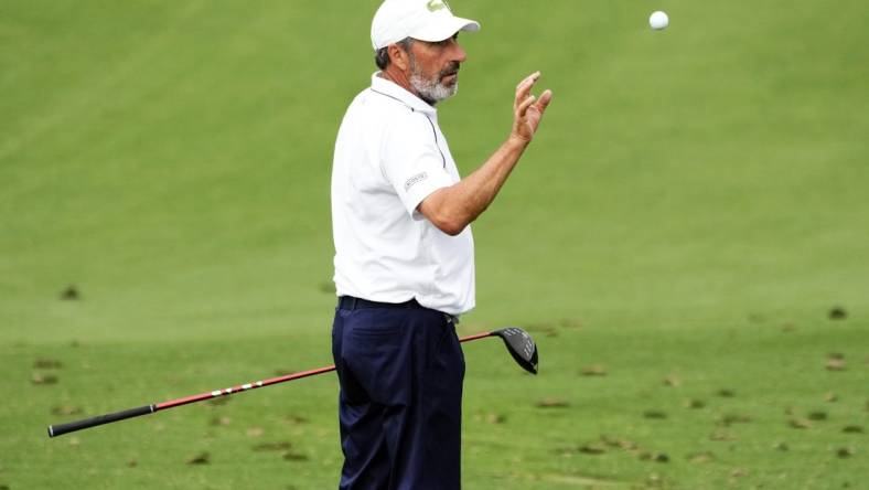 Apr 3, 2023; Augusta, Georgia, USA; Jose Maria Olazabal catches a ball tossed by his caddie on the practice range during a practice round for The Masters golf tournament at Augusta National Golf Club. Mandatory Credit: Rob Schumacher-USA TODAY Network