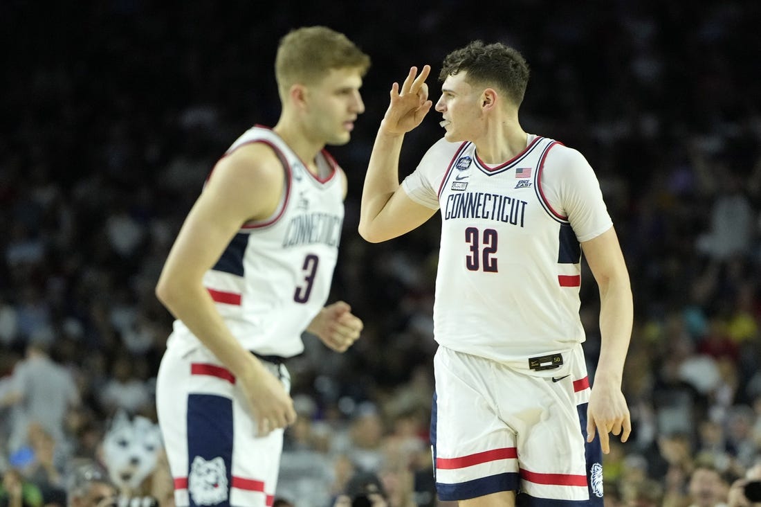 Apr 3, 2023; Houston, TX, USA; Connecticut Huskies center Donovan Clingan (32) reacts after a play against the San Diego State Aztecs during the first half in the national championship game of the 2023 NCAA Tournament at NRG Stadium. Mandatory Credit: Bob Donnan-USA TODAY Sports