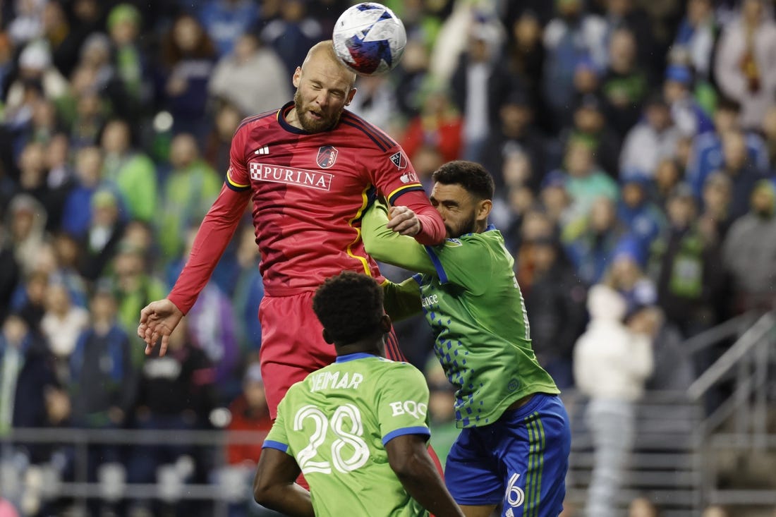 Apr 8, 2023; Seattle, Washington, USA; St. Louis City forward Klauss (9) heads the ball against Seattle Sounders midfielder Joao Paulo (6) during the second half at Lumen Field. Mandatory Credit: Joe Nicholson-USA TODAY Sports