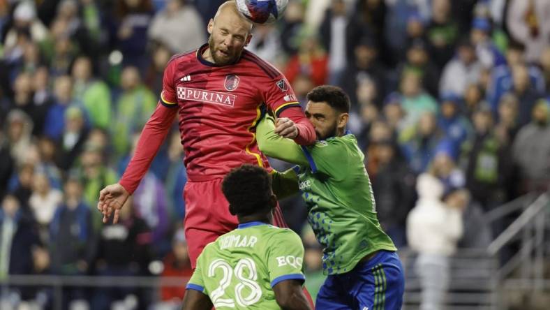 Apr 8, 2023; Seattle, Washington, USA; St. Louis City forward Klauss (9) heads the ball against Seattle Sounders midfielder Joao Paulo (6) during the second half at Lumen Field. Mandatory Credit: Joe Nicholson-USA TODAY Sports