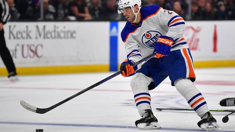 Apr 23, 2023; Los Angeles, California, USA; Edmonton Oilers defenseman Evan Bouchard (2) moves the puck against the Los Angeles Kings during the third period in game four of the first round of the 2023 Stanley Cup Playoffs at Crypto.com Arena. Mandatory Credit: Gary A. Vasquez-USA TODAY Sports