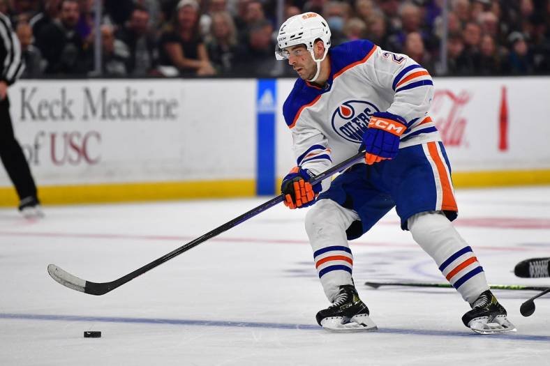 Apr 23, 2023; Los Angeles, California, USA; Edmonton Oilers defenseman Evan Bouchard (2) moves the puck against the Los Angeles Kings during the third period in game four of the first round of the 2023 Stanley Cup Playoffs at Crypto.com Arena. Mandatory Credit: Gary A. Vasquez-USA TODAY Sports