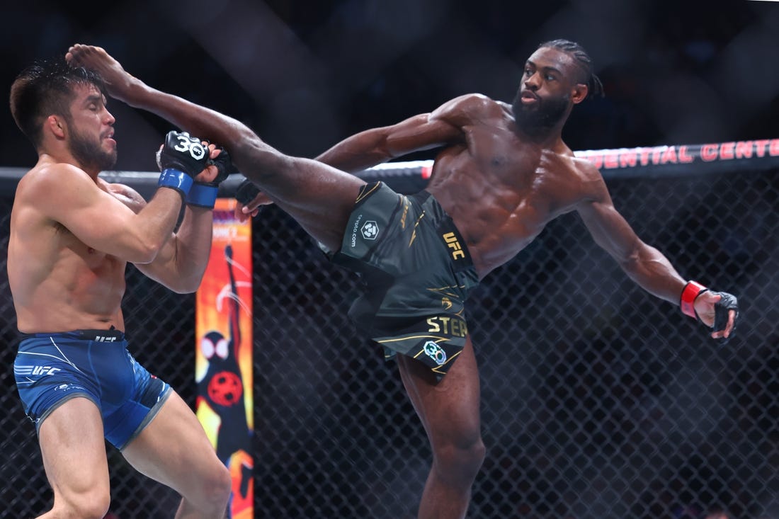 May 6, 2023; Newark, New Jersey, USA; Aljamain Sterling (red gloves) fights Henry Cejudo (blue gloves) during UFC 288 at Prudential Center. Mandatory Credit: Ed Mulholland-USA TODAY Sports