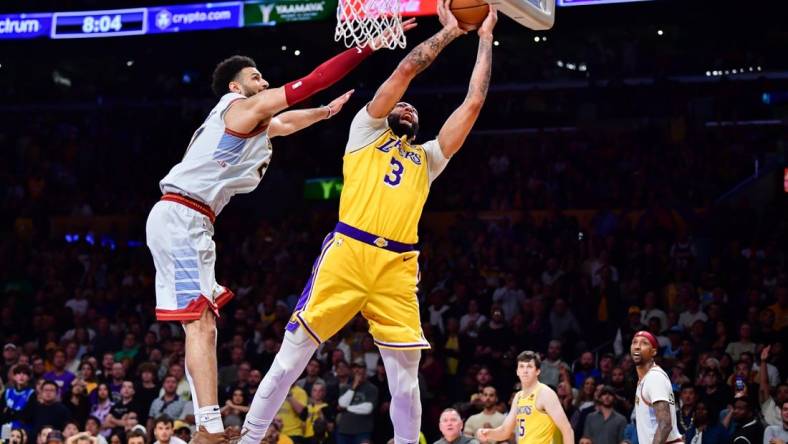 May 22, 2023; Los Angeles, California, USA; Los Angeles Lakers forward Anthony Davis (3) is fouled by Denver Nuggets guard Jamal Murray (27) during the fourth quarter in game four of the Western Conference Finals for the 2023 NBA playoffs at Crypto.com Arena. Mandatory Credit: Gary A. Vasquez-USA TODAY Sports