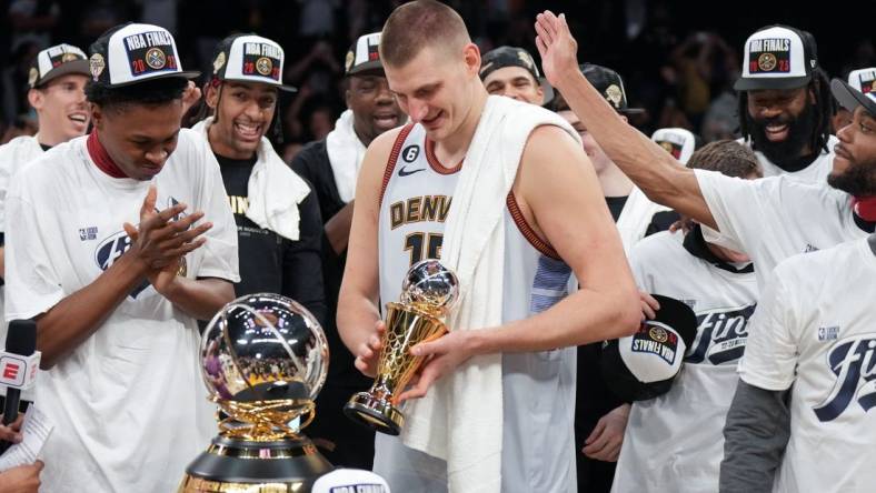 May 22, 2023; Los Angeles, California, USA; Denver Nuggets center Nikola Jokic (15) celebrates winning the Western Conference MVP Trophy and beating the Los Angeles Lakers in game four of the Western Conference Finals for the 2023 NBA playoffs at Crypto.com Arena. Mandatory Credit: Kirby Lee-USA TODAY Sports