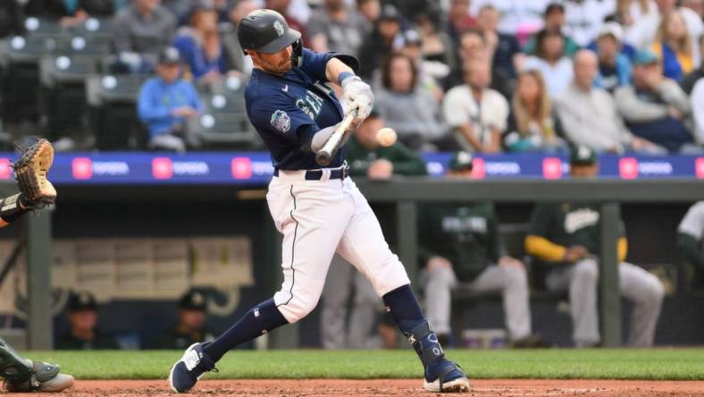 May 24, 2023; Seattle, Washington, USA; Seattle Mariners left fielder AJ Pollock (8) hits a single against the Oakland Athletics during the fourth inning at T-Mobile Park. Mandatory Credit: Steven Bisig-USA TODAY Sports