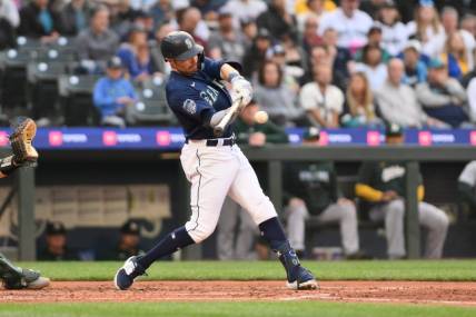 May 24, 2023; Seattle, Washington, USA; Seattle Mariners left fielder AJ Pollock (8) hits a single against the Oakland Athletics during the fourth inning at T-Mobile Park. Mandatory Credit: Steven Bisig-USA TODAY Sports