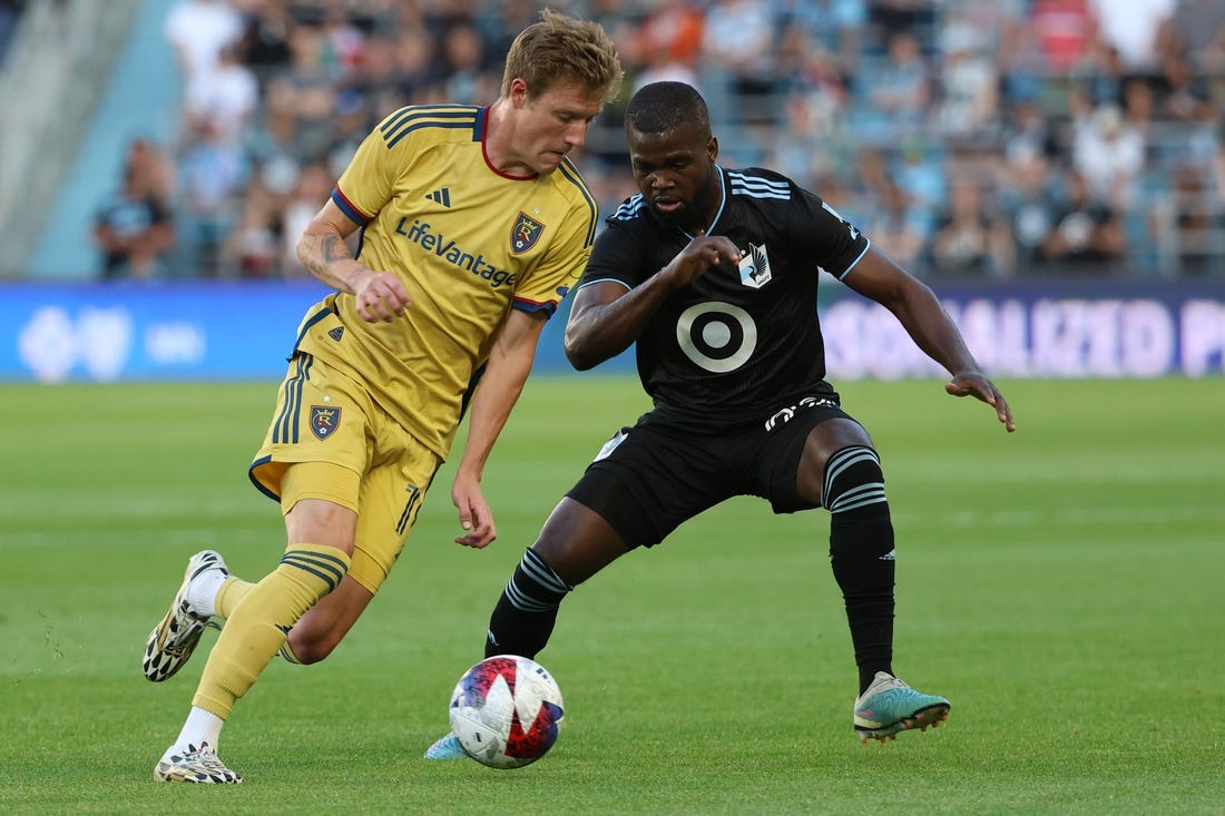 May 27, 2023; Saint Paul, Minnesota, USA; Real Salt Lake midfielder Bode Hidalgo (19) dribbles the past Minnesota United defender Kemar Lawrence (92) during the game at Allianz Field. Mandatory Credit: Matt Krohn-USA TODAY Sports