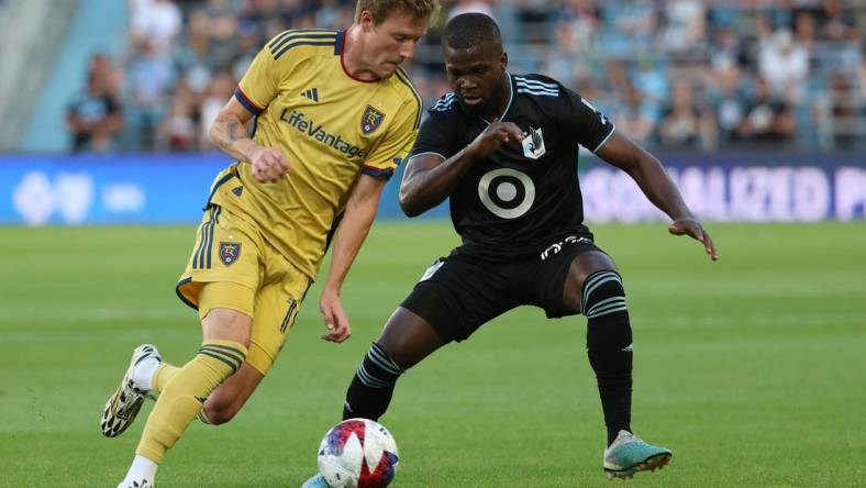 May 27, 2023; Saint Paul, Minnesota, USA; Real Salt Lake midfielder Bode Hidalgo (19) dribbles the past Minnesota United defender Kemar Lawrence (92) during the game at Allianz Field. Mandatory Credit: Matt Krohn-USA TODAY Sports