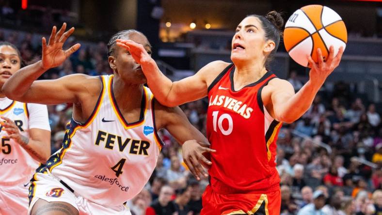 Jun 4, 2023; Indianapolis, Indiana, USA; Las Vegas Aces guard Kelsey Plum (10) shoots the ball while Indiana Fever center Queen Egbo (4) defends in the second half at Gainbridge Fieldhouse. Mandatory Credit: Trevor Ruszkowski-USA TODAY Sports