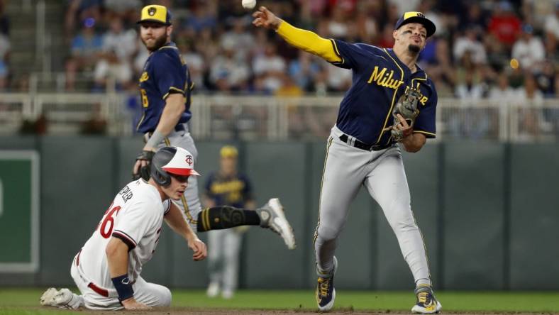 Jun 13, 2023; Minneapolis, Minnesota, USA; Milwaukee Brewers second baseman Luis Urias (2) forces out Minnesota Twins pinch hitter Max Kepler (26) but cannot turn the double play in the eighth inning at Target Field. Mandatory Credit: Bruce Kluckhohn-USA TODAY Sports