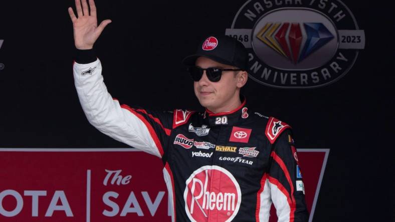 Jun 11, 2023; Sonoma, California, USA;  NASCAR Cup Series driver Christopher Bell (20) waves at the crowd before the start of the Toyota / Save Mart 350 at Sonoma Raceway. Mandatory Credit: Stan Szeto-USA TODAY Sports