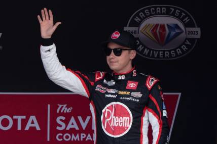 Jun 11, 2023; Sonoma, California, USA;  NASCAR Cup Series driver Christopher Bell (20) waves at the crowd before the start of the Toyota / Save Mart 350 at Sonoma Raceway. Mandatory Credit: Stan Szeto-USA TODAY Sports