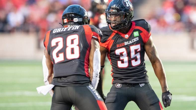 Jun 15, 2023; Ottawa, Ontario, CAN; Ottawa REDBLACKS lineback Frankie Griffin (28) and defensive back Douglas Coleman (35) celebrate a broken play against the Calgary Stampeders in the first half against the  at TD Place. Mandatory Credit: Marc DesRosiers-USA TODAY Sports