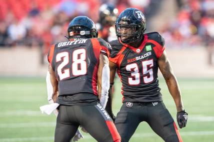 Jun 15, 2023; Ottawa, Ontario, CAN; Ottawa REDBLACKS lineback Frankie Griffin (28) and defensive back Douglas Coleman (35) celebrate a broken play against the Calgary Stampeders in the first half against the  at TD Place. Mandatory Credit: Marc DesRosiers-USA TODAY Sports