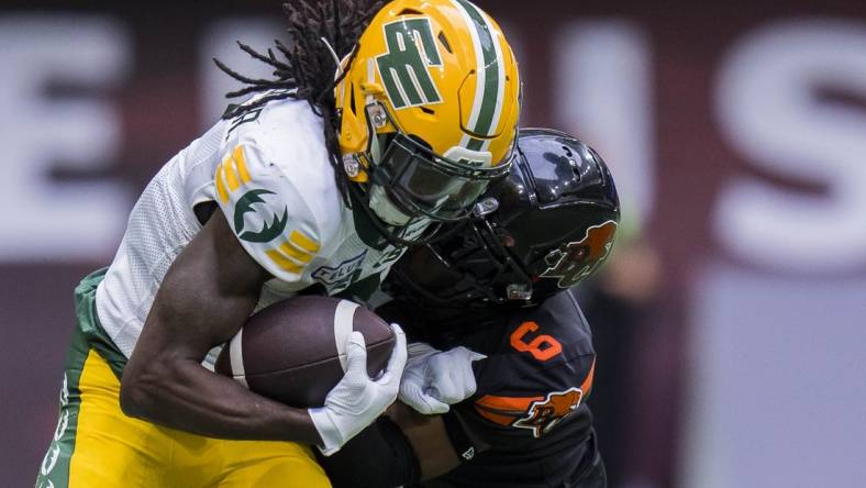 Jun 17, 2023; Vancouver, British Columbia, CAN; BC Lions defensive back TJ Lee (6) tackles Edmonton Elks receiver Steven Dunbar Jr. (7) in the second half at BC Place. BC won 22-0. Mandatory Credit: Bob Frid-USA TODAY Sports