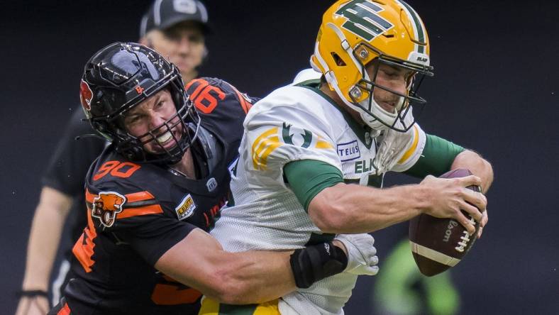 Jun 17, 2023; Vancouver, British Columbia, CAN; BC Lions defensive lineman Mathieu Betts (90) sacks Edmonton Elks quarterback Taylor Cornelius (15) in the second half at BC Place. BC won 22-0. Mandatory Credit: Bob Frid-USA TODAY Sports