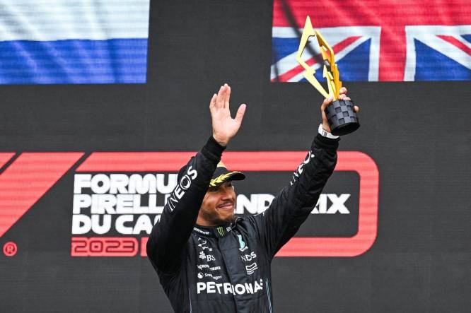 Jun 18, 2023; Montreal, Quebec, CAN; Mercedes driver Lewis Hamilton (GBR) salutes the crowd holding his third place trophy of the Canadian Grand Prix at Circuit Gilles Villeneuve. Mandatory Credit: David Kirouac-USA TODAY Sports