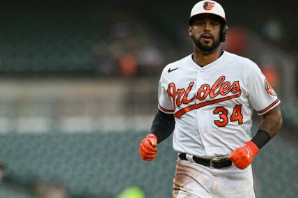 Jun 27, 2023; Baltimore, Maryland, USA;  Baltimore Orioles left fielder Aaron Hicks (34) scores on  right fielder Ryan McKenna (not pictured) second inning sacrifice fly Cincinnati Reds  at Oriole Park at Camden Yards. Mandatory Credit: Tommy Gilligan-USA TODAY Sports