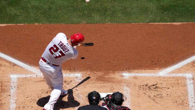 Jul 2, 2023; Anaheim, California, USA; Los Angeles Angels center fielder Mike Trout (27) hits a solo home run in the first inning against the Arizona Diamondbacks at Angel Stadium. Mandatory Credit: Kirby Lee-USA TODAY Sports